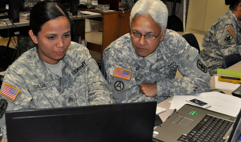 Members from the 29th Brigade Support work on computer simulations