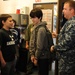 Sailor shows how a flotation device works to students