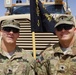 Two Kentucky soldiers pose together with their unit flag in southern Afghanistan