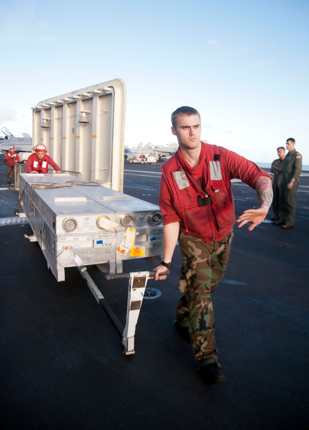 USS George Washington sailors move crates