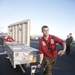 USS George Washington sailors move crates