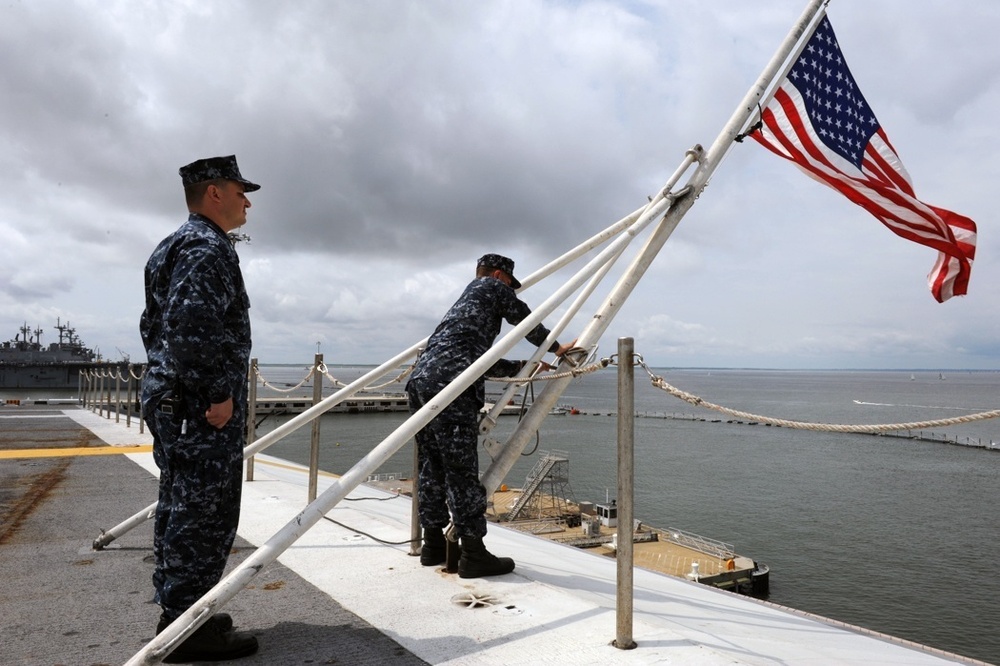 USS George H.W. Bush sailors lower flag in remembrance of shooting victims