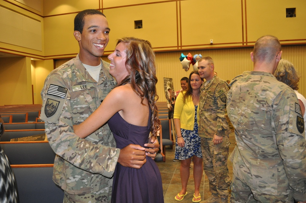 Soldier embraces spouse after yearlong deployment