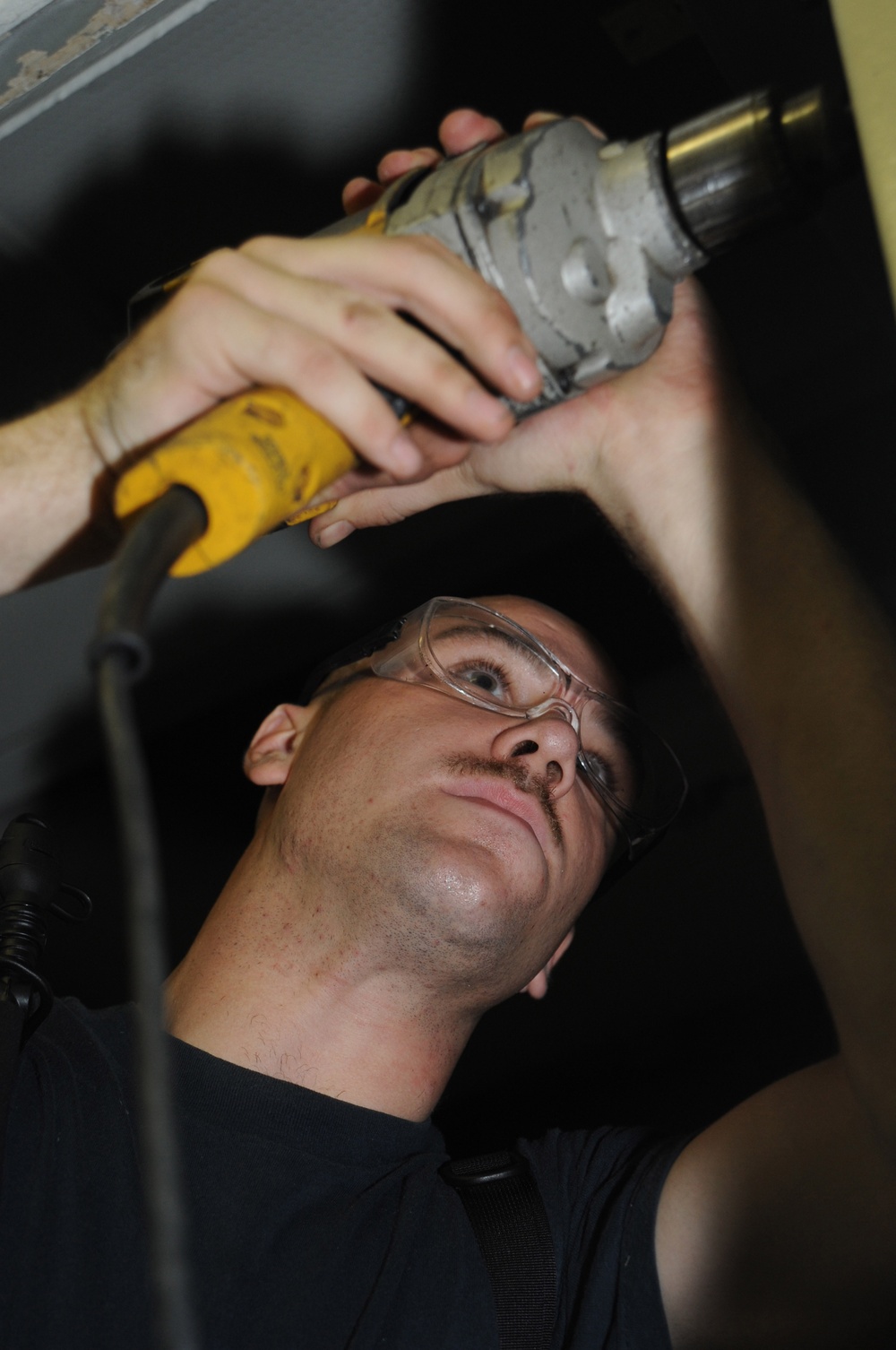 USS Dwight D. Eisenhower sailor repairs door