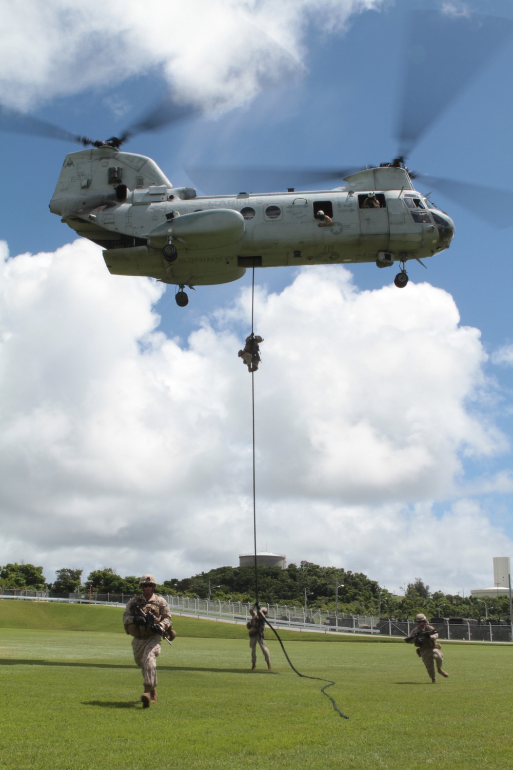 U.S. Marines fast-rope from a CH-46E Sea Knight helicopter onto
