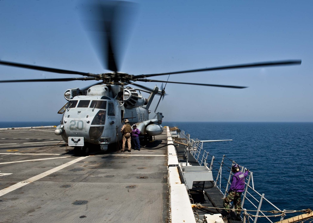 Refueling a Marine Corps CH-53E Super Stallion helicopter