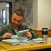 Fighter Squadron pilot reads flight publication before pre-flight briefing