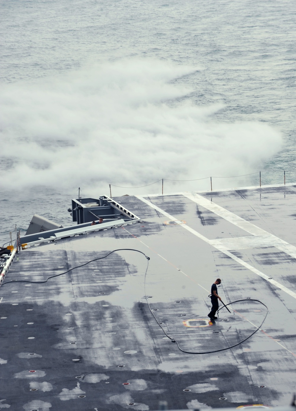 USS George Washington sailor dries flight deck