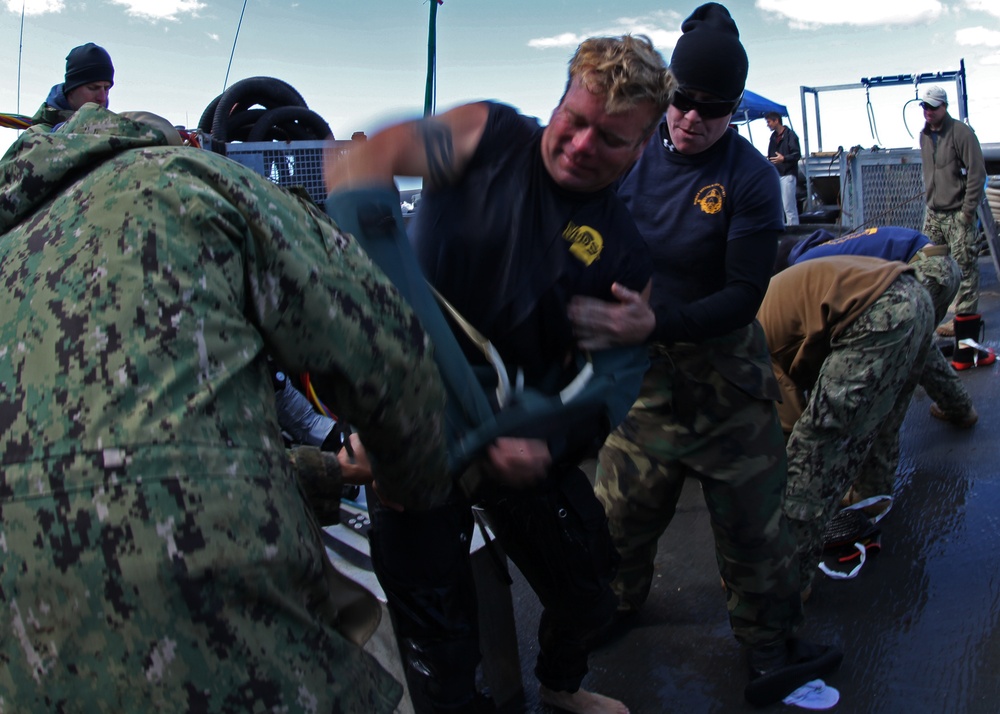 US Navy divers search for the remains of five unaccounted for service members from 1942