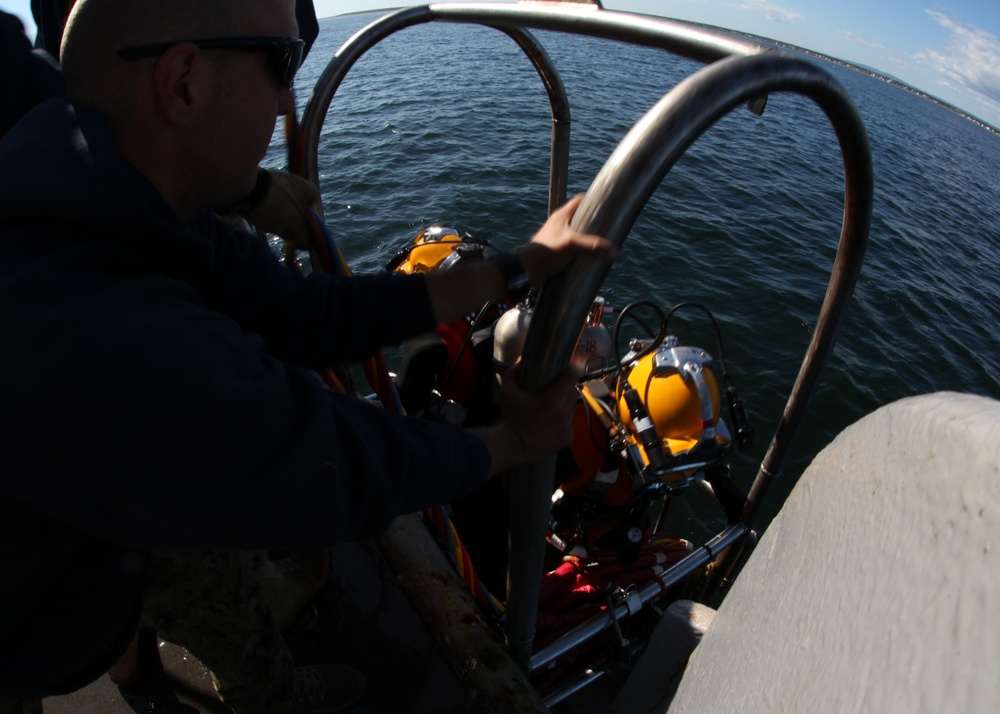 US Navy divers search for the remains of five unaccounted for service members from 1942