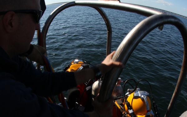 US Navy divers search for the remains of five unaccounted for service members from 1942