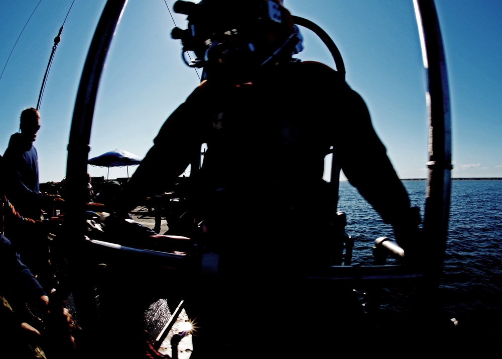 US Navy divers search for the remains of five unaccounted for service members from 1942