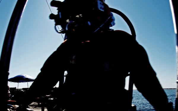 US Navy divers search for the remains of five unaccounted for service members from 1942