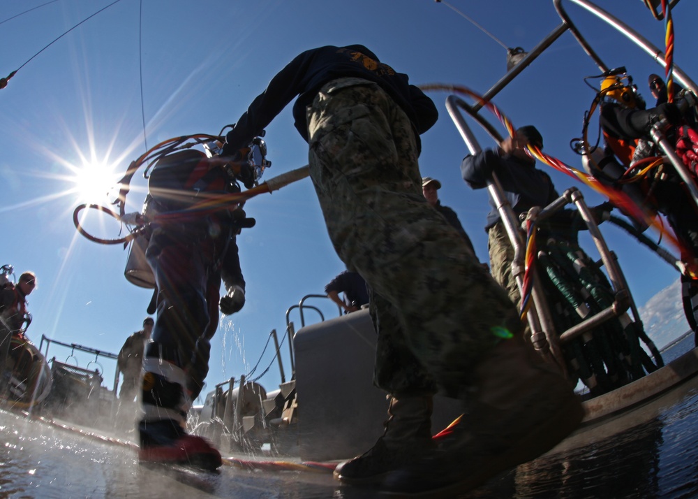 US Navy divers search for the remains of five unaccounted for service members from 1942