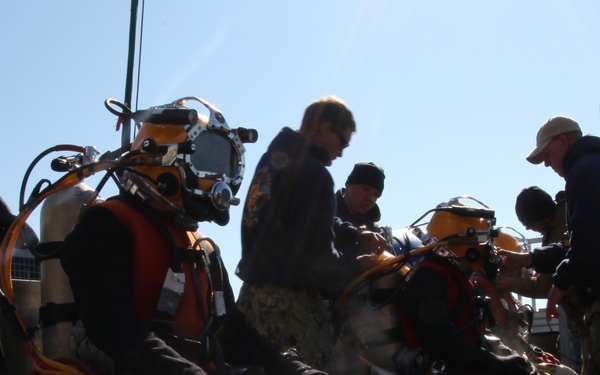 US Navy divers search for the remains of five unaccounted for service members from 1942