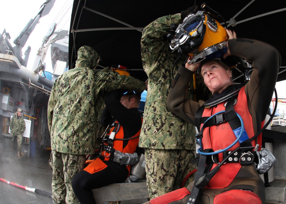 US Navy divers search for the remains of five unaccounted for service members from 1942