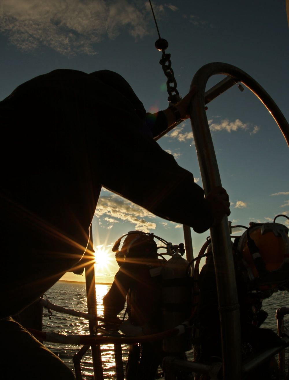 US Navy divers search for the remains of five unaccounted for service members from 1942