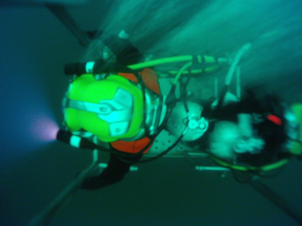 US Navy divers search for the remains of five unaccounted for service members from 1942