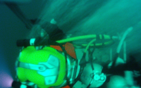 US Navy divers search for the remains of five unaccounted for service members from 1942