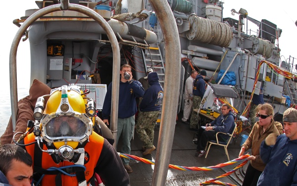 US Navy divers search for the remains of five un-accounted for service members from 1942