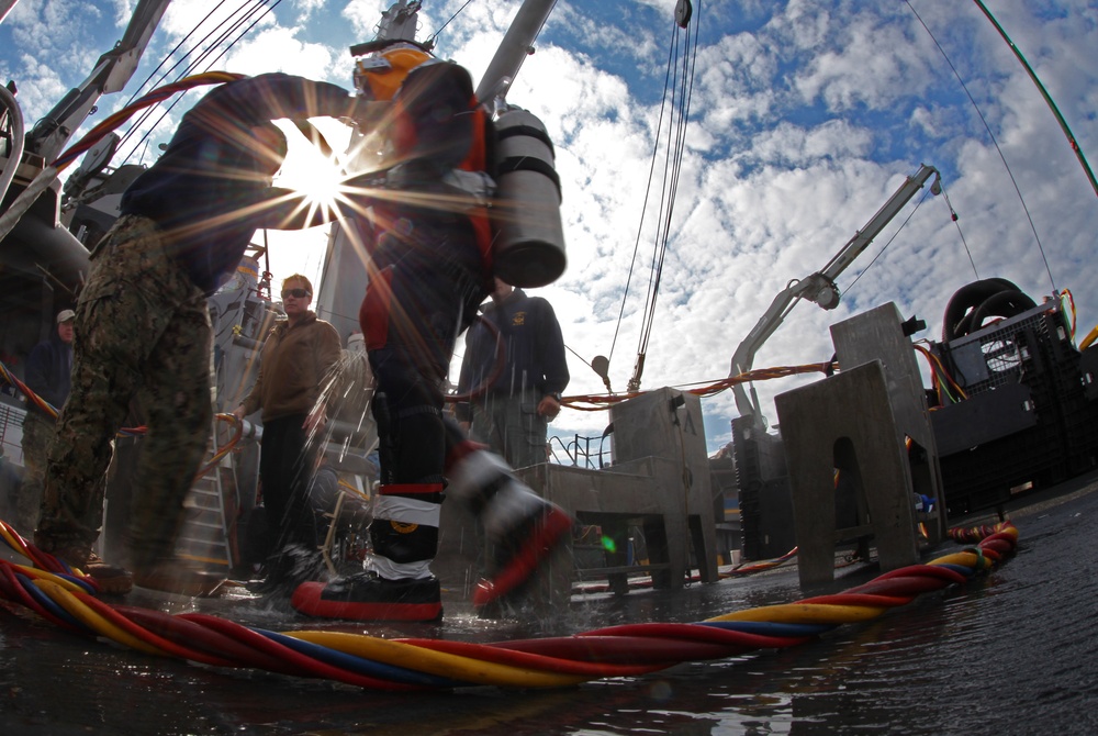 US Navy divers search for the remains of five un-accounted for service members from 1942