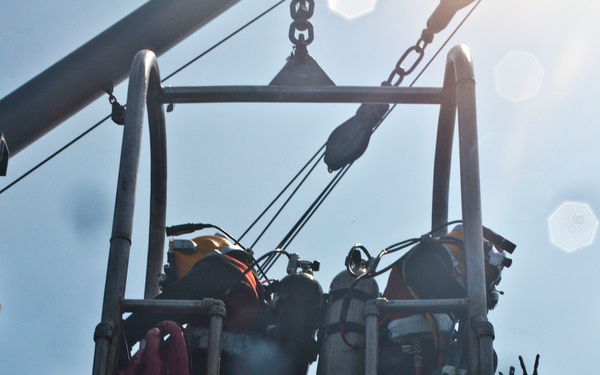 US Navy divers search for the remains of five un-accounted for service members from 1942