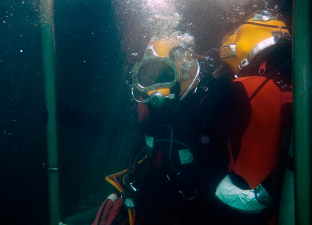 US Navy divers search for the remains of 5 un-accounted for service members from 1942