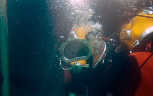 US Navy divers search for the remains of 5 un-accounted for service members from 1942