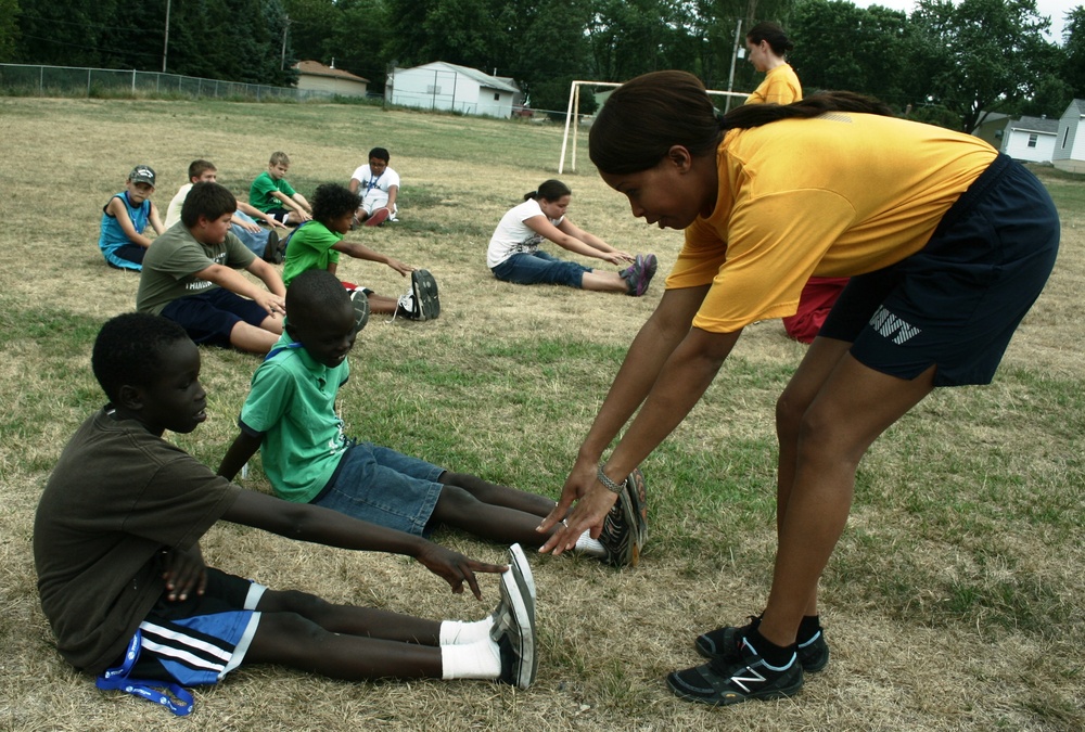 USS Rushmore sailor helps during physical fitness session with kids