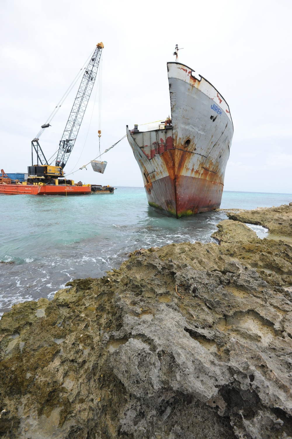 Response crews remove sections of grounded freighter
