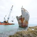 Response crews remove sections of grounded freighter