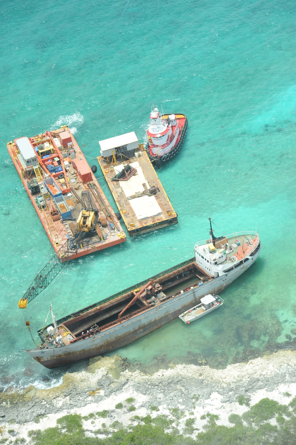 Response crews remove sections of grounded freighter