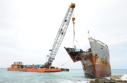 Response crews remove sections of grounded freighter