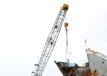 Response crews remove sections of grounded freighter