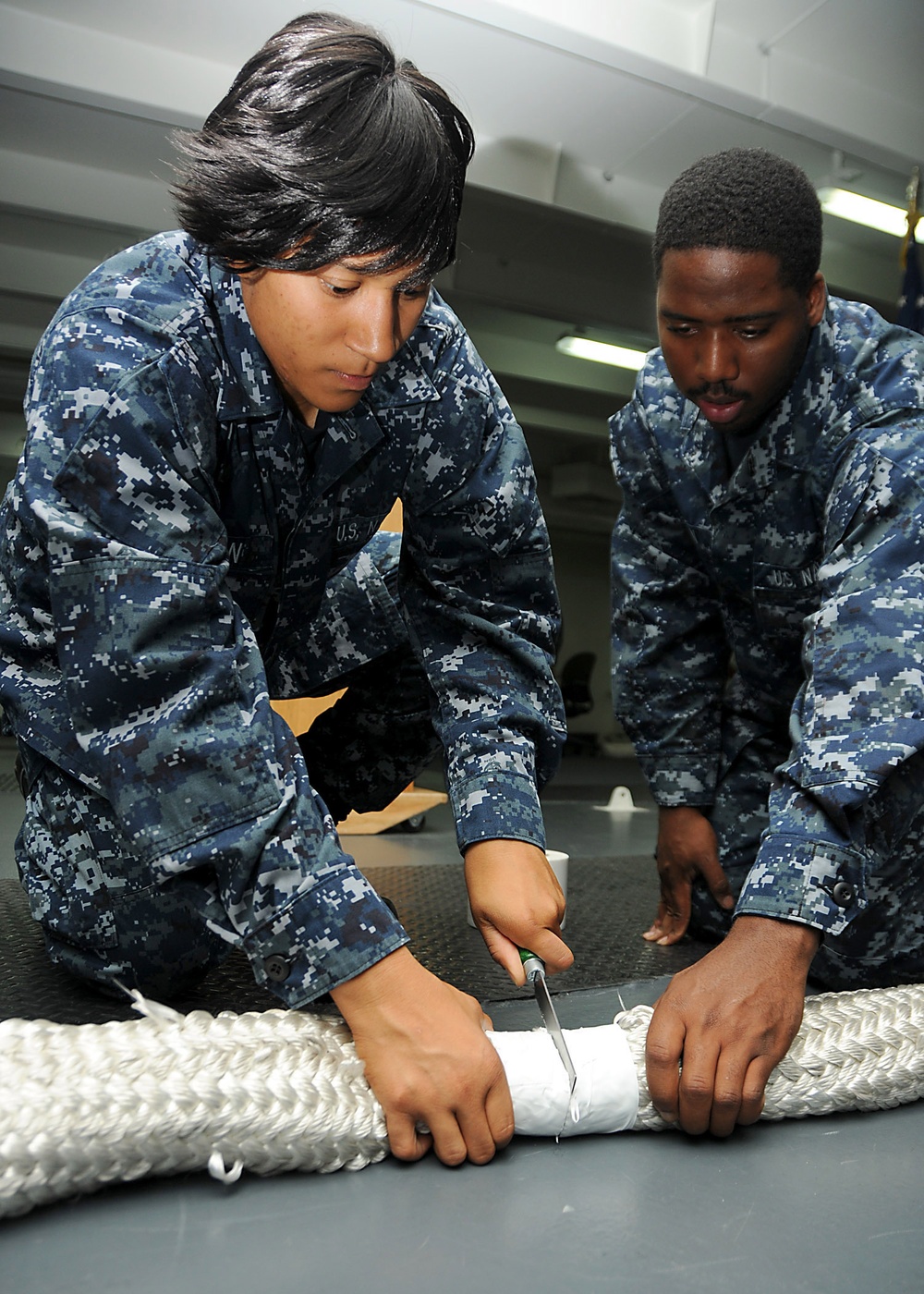 USS Ronald Reagan sailors cut mooring line