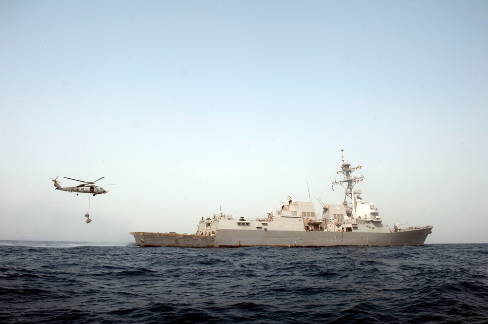 SH-60B Sea Hawk helicopter delivers cargo to USS Nitze