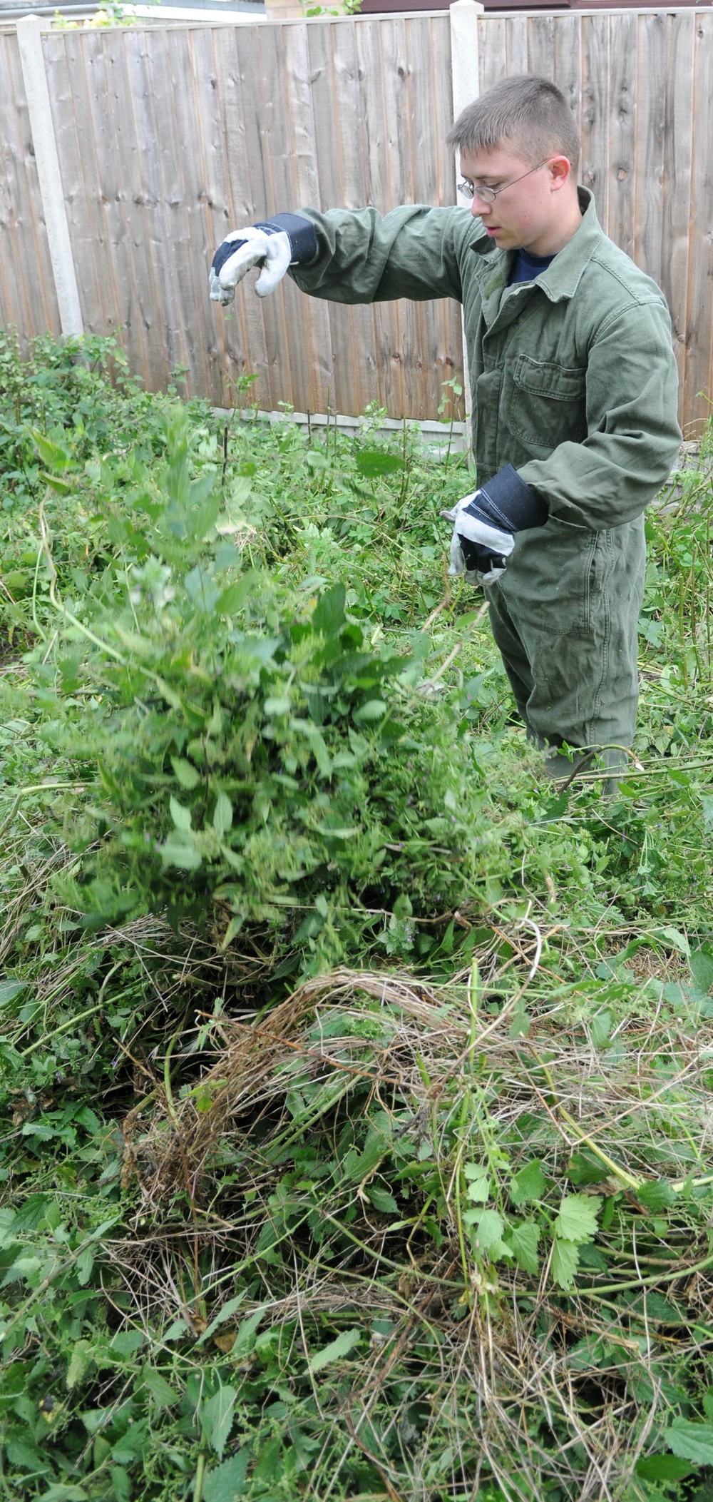 Volunteers help clear garden for local disabled homeowner