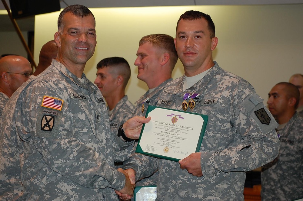 Two-time Purple Heart awardee poses with commander
