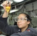 USS Bohomme Richard sailor inspects fuel sample