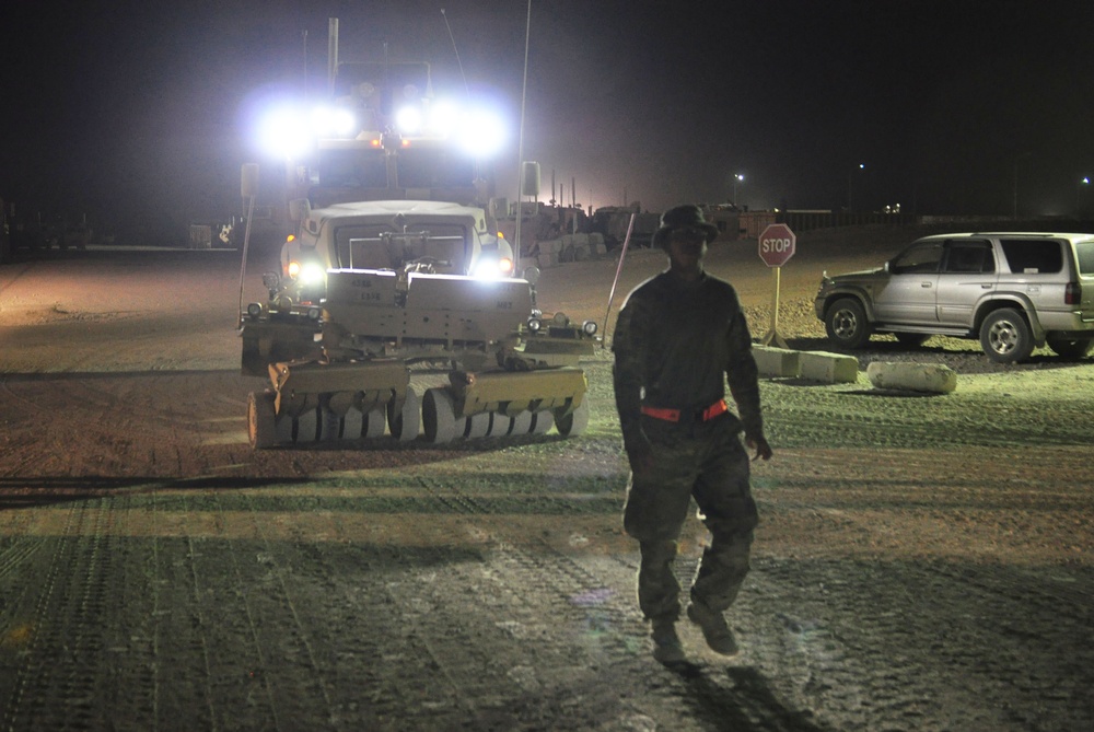 Soldiers transport cargo during night