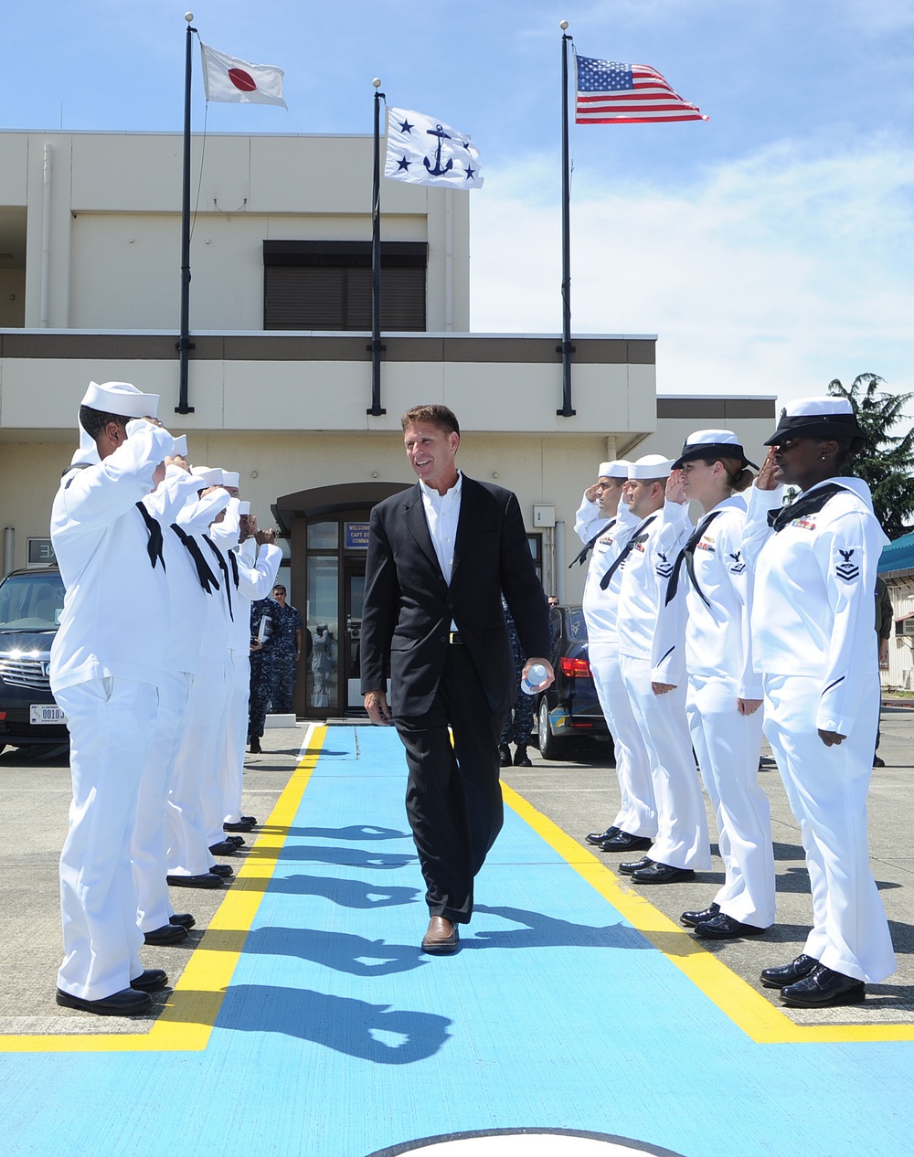 Assistant secretary of the Navy walks through sideboys