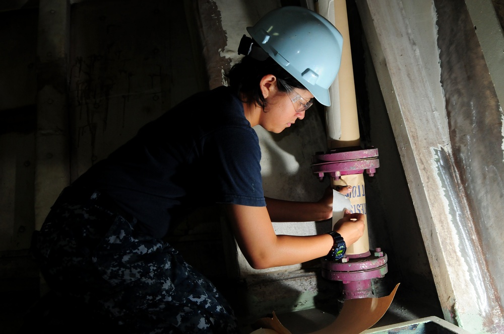 USS Carl Vinson sailor prepares to paint