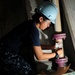 USS Carl Vinson sailor prepares to paint