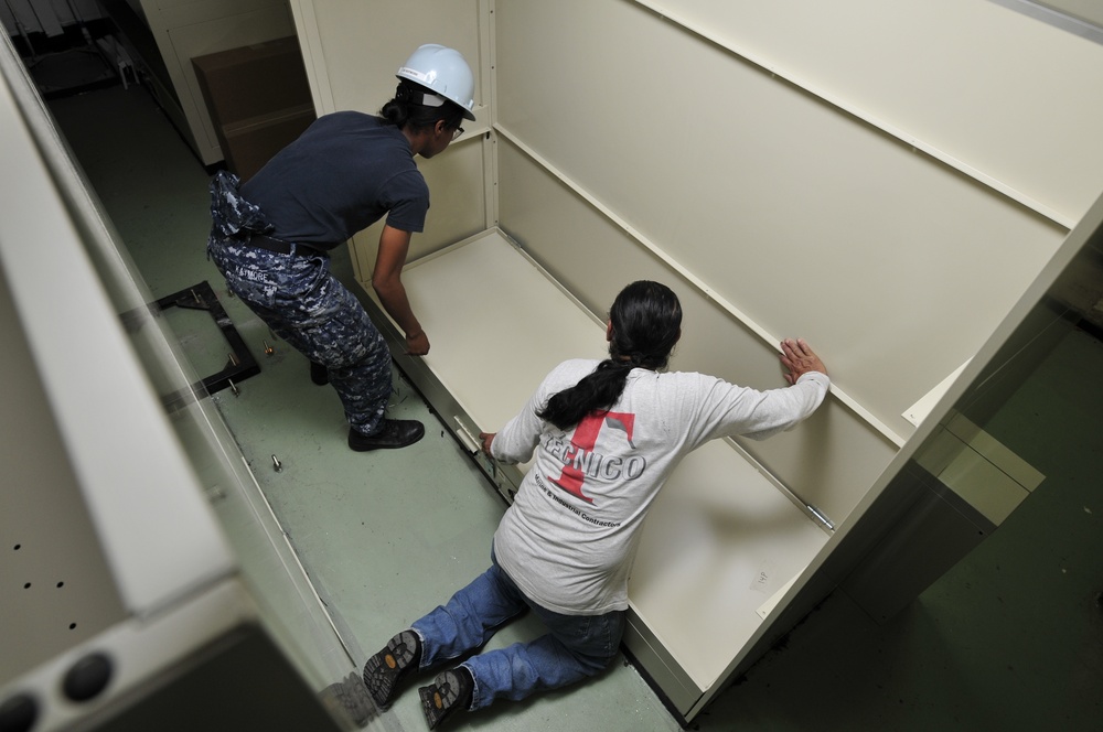 USS Carl Vinson sailors install racks