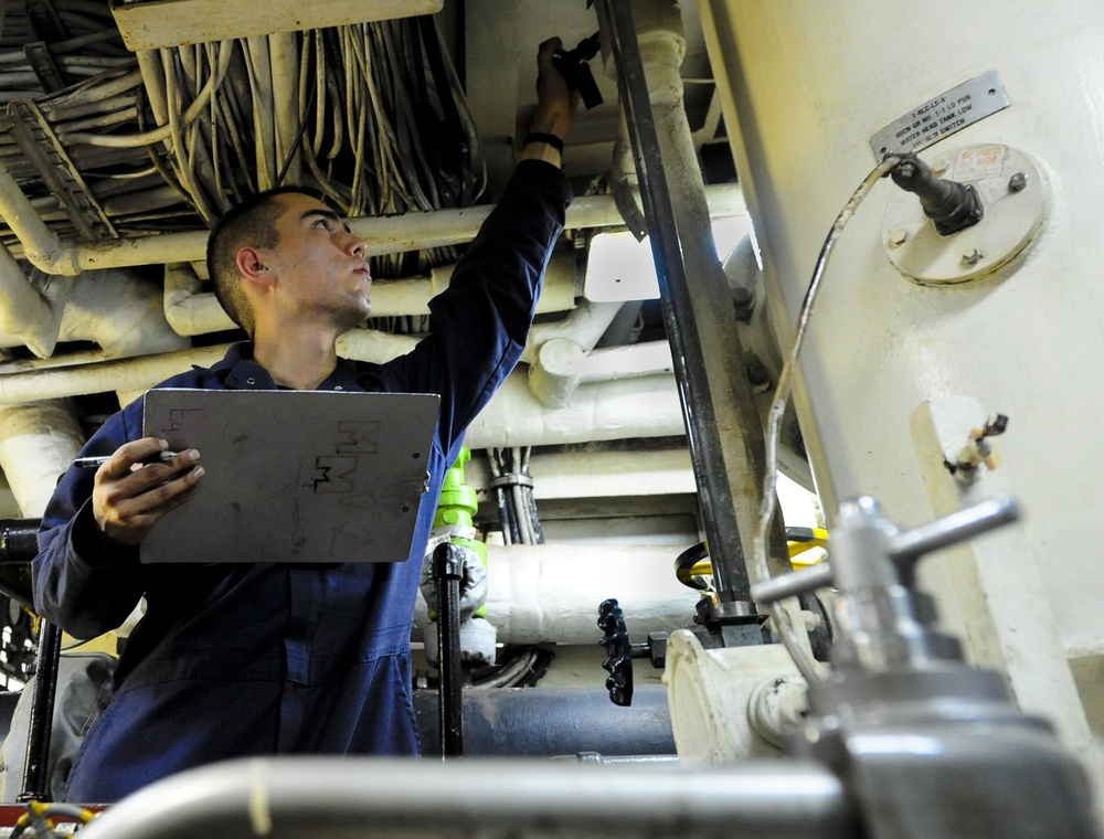 USS Tortuga sailor checks tank