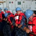 USS George Washington sailors heave on a line