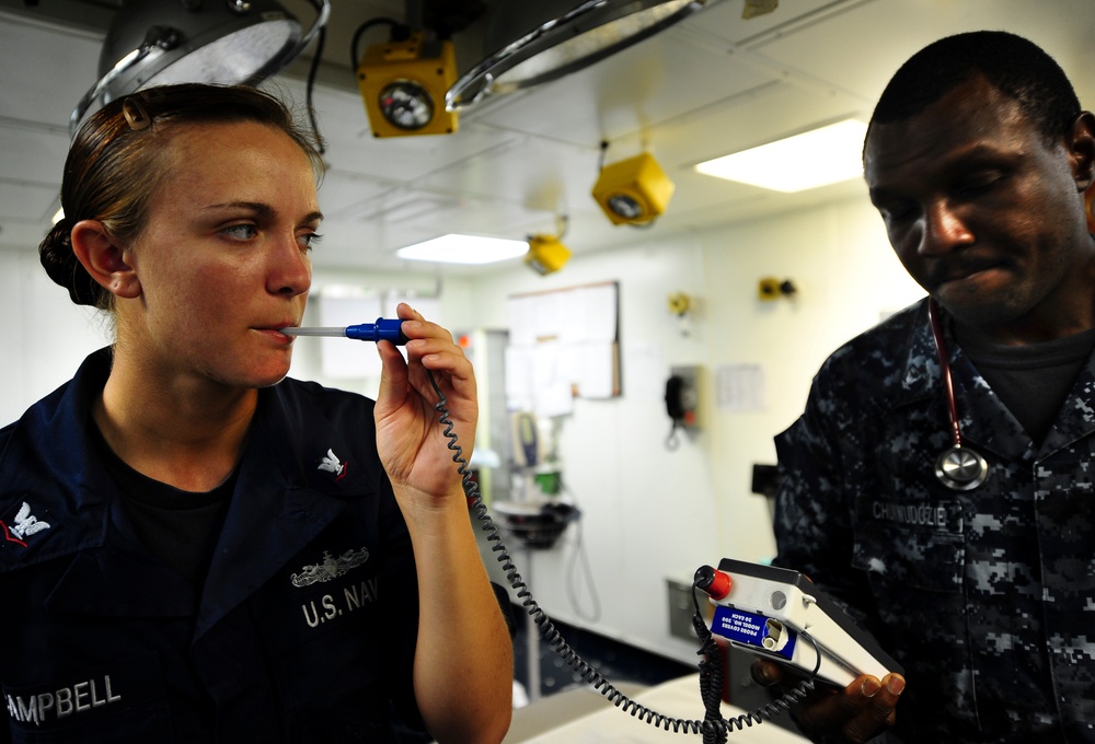 USS Tortuga sailor checks temperature