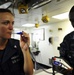 USS Tortuga sailor checks temperature