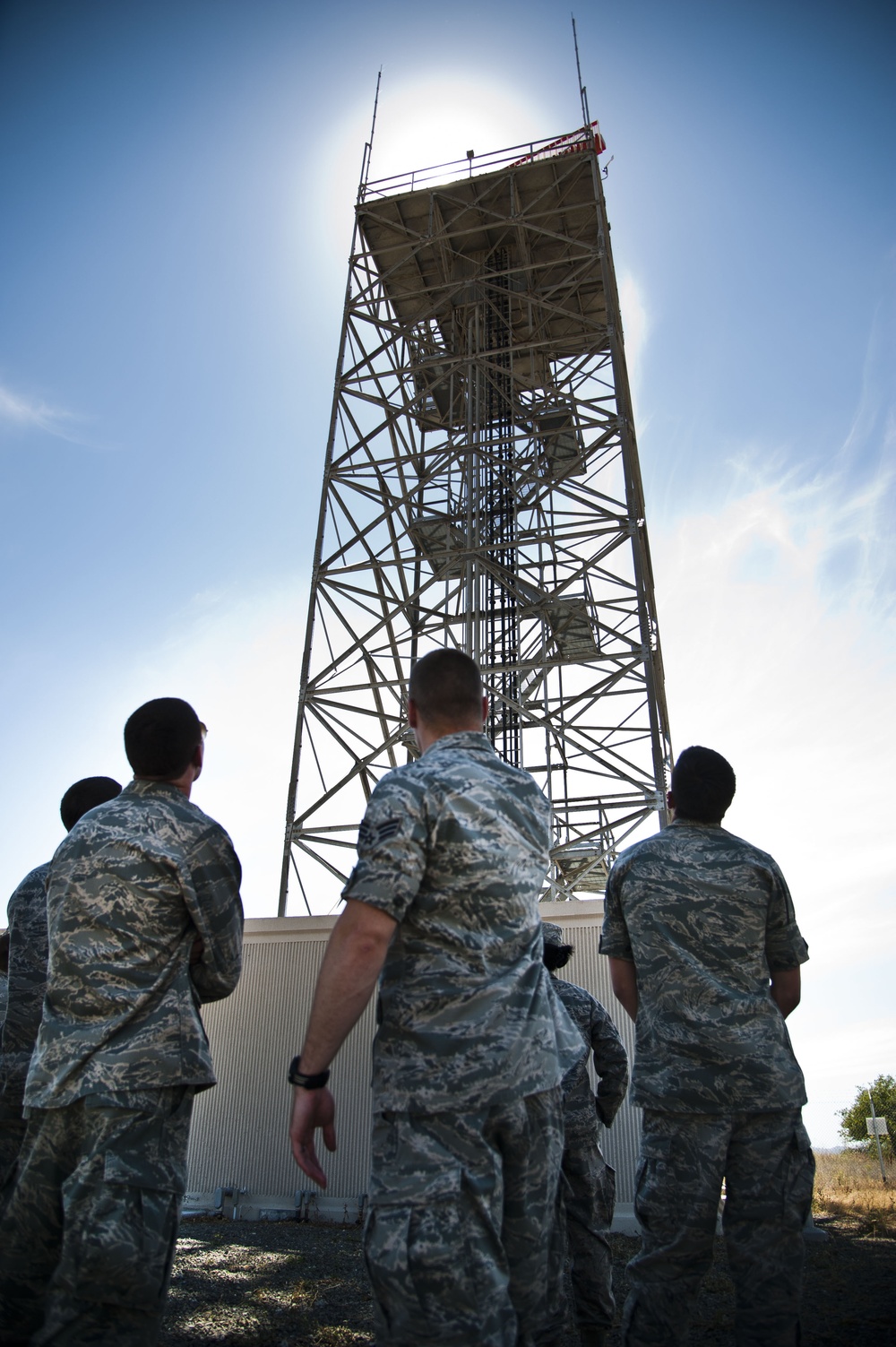 Airman stand in front of radar tower