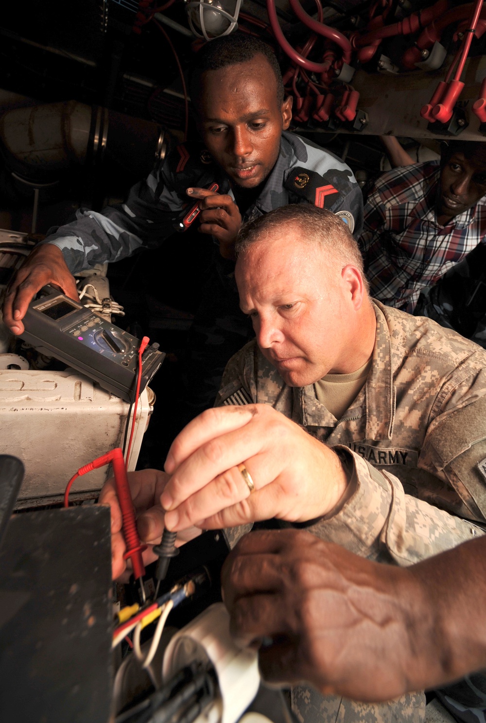 Partnering with US soldiers assists Djiboutian Sailors in fixing patrol boats